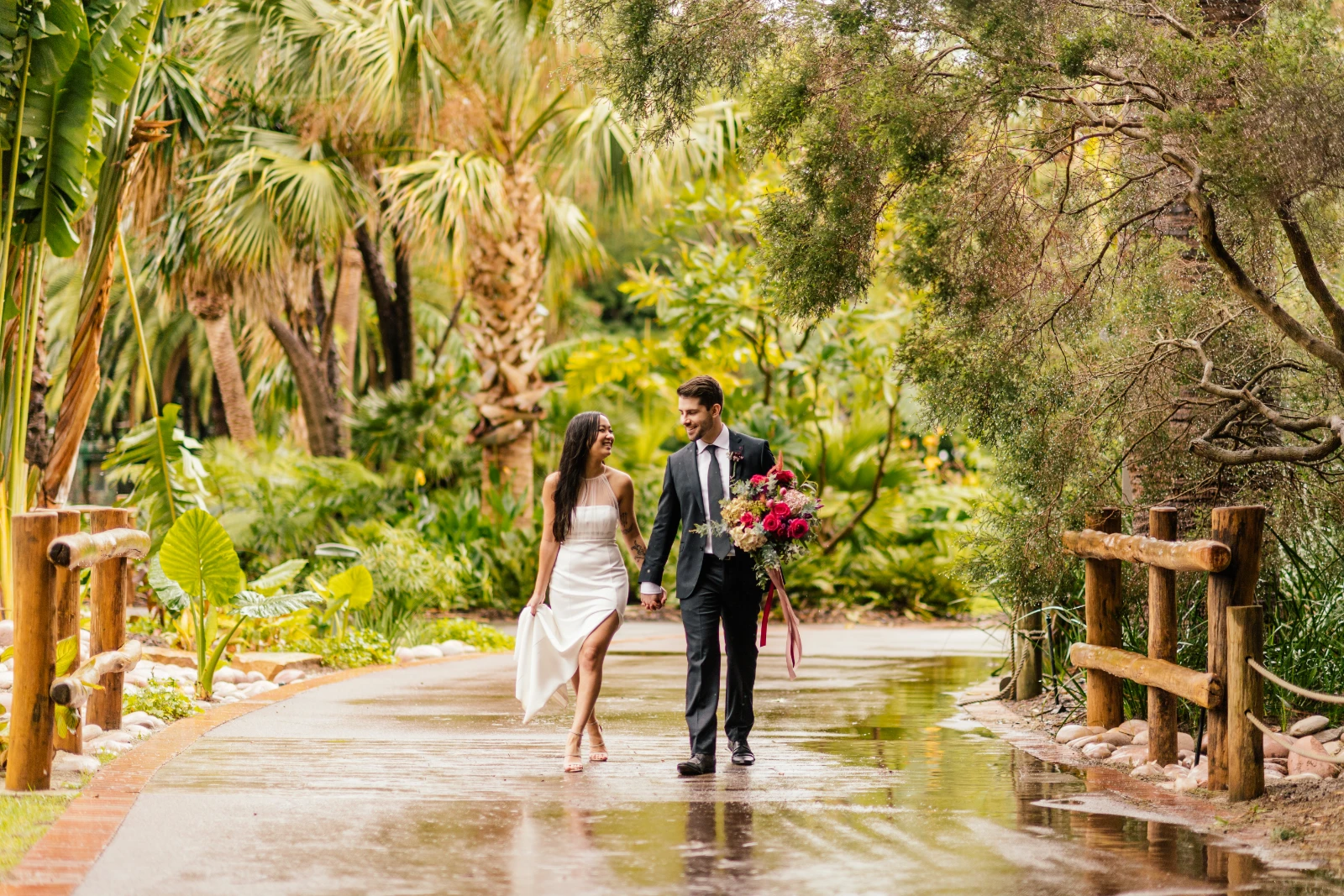 A newly wedded couple walking at The Maali, a unique outdoor wedding venue in Perth.