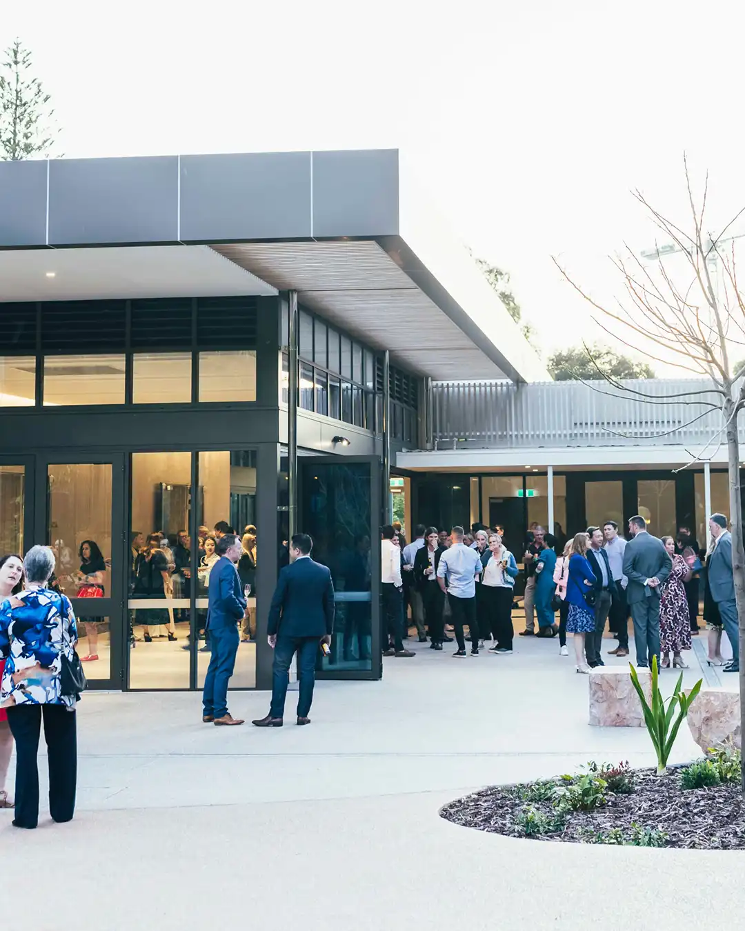 Guests mingling outside modern Perth wedding and event venue courtyard